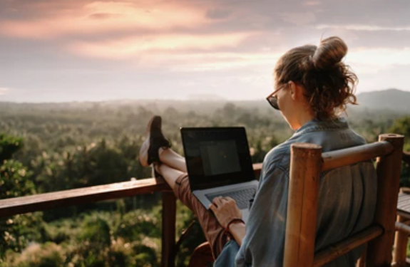 A lady doing remote job from the rooftop of a cafe